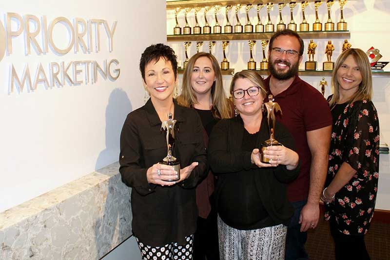 Teri Hansen Nicki McTeague Olivia Orth Jonathan Price and Melissa Mitchell hold Priority Marketing Addy Awards