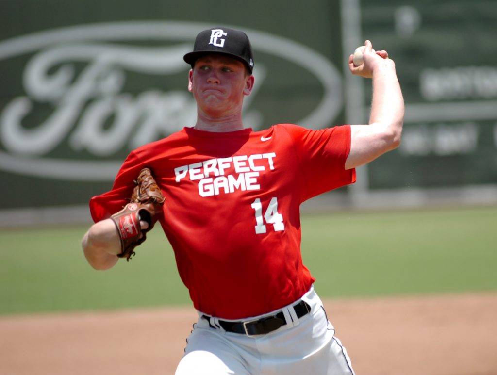 High school baseball player in red 14 throws the ball during National Showcase