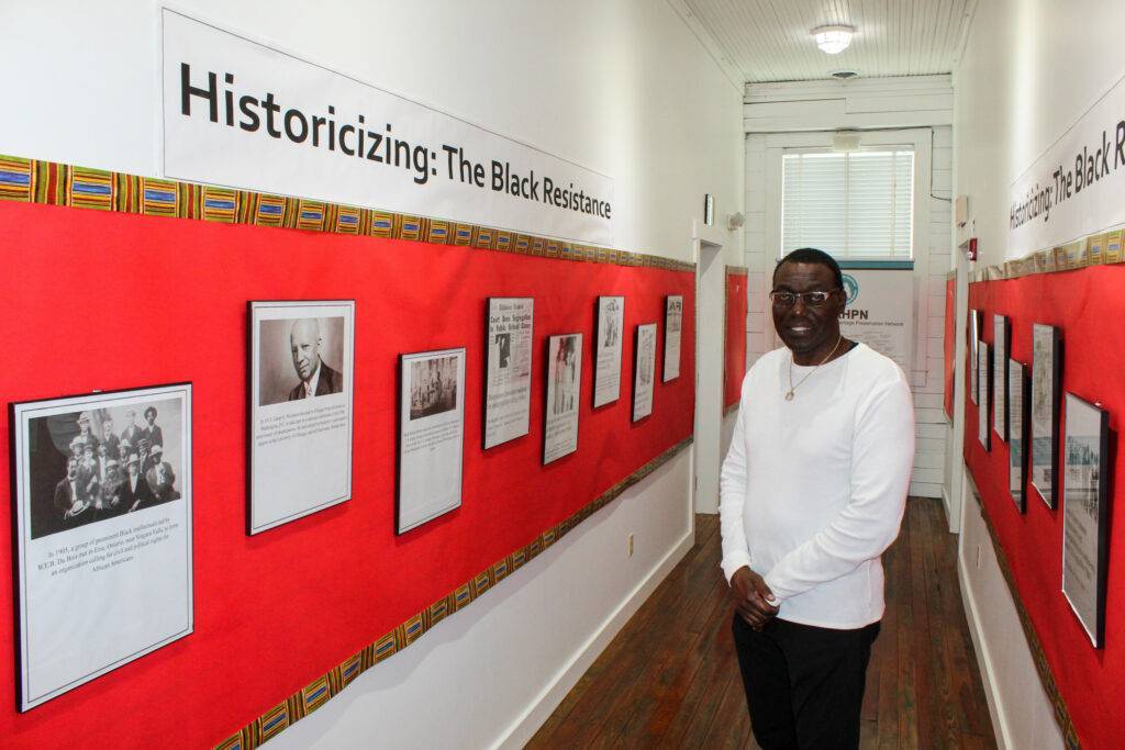 Charles Barnes stands in Black Resistance exhibit at Williams Academy